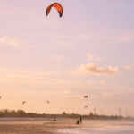 Kitesurfers on Parajuru beach at dusk