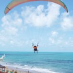 Paraglider flying above the beach of Canoa Quebrada in Ceará