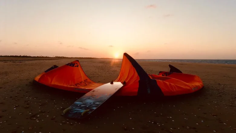 Kites and board on the beach at sunset in Parajuru