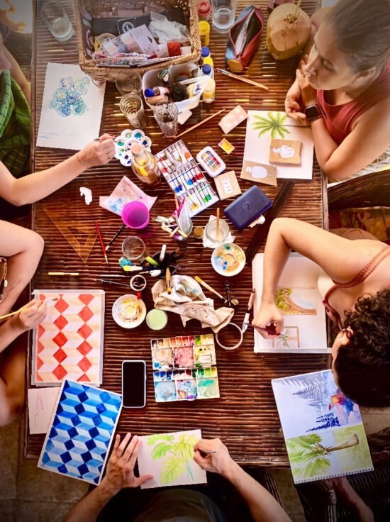 Guests painting watercolours during a creative workshop at Caju Knots, Parajuru