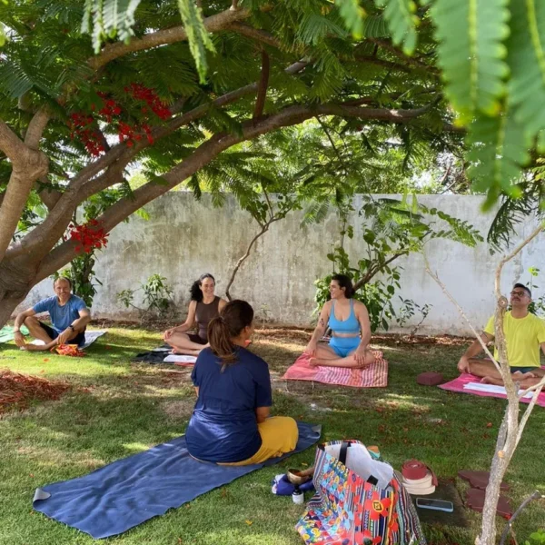 Group yoga class in the garden at Caju Knots, Parajuru, Brazil