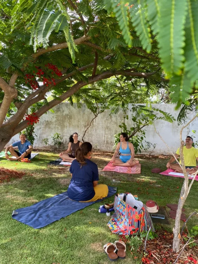 Group yoga class in the garden at Caju Knots, Parajuru, Brazil