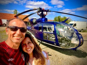 Xavier and Priscilla next to a helicopter