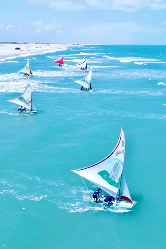 Traditional jangada sailboats on the turquoise sea of Ceará, Brazil