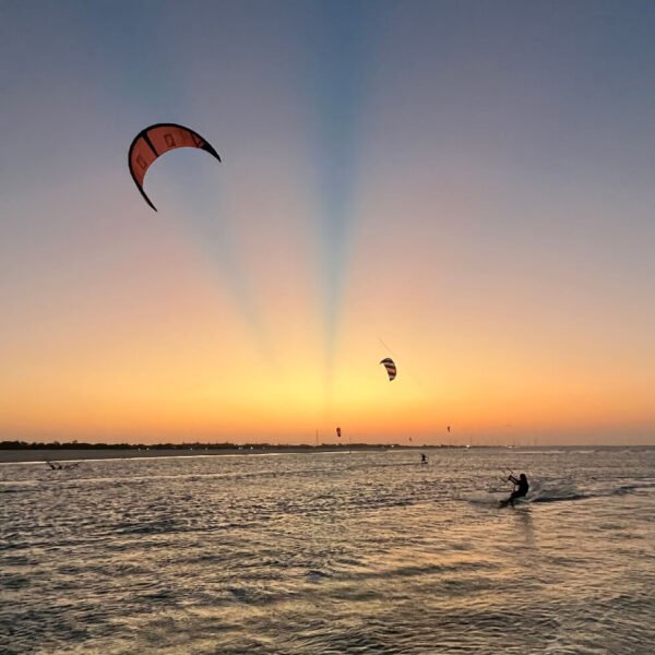 Kitesurfers riding at sunset on the flat water of Parajuru, Ceará, Brazil
