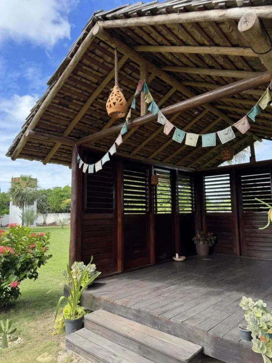 Shaded wooden pavilion in the garden of Caju Knots, used for yoga sessions