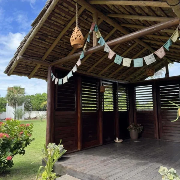 Shaded wooden pavilion in the garden of Caju Knots, used for yoga sessions