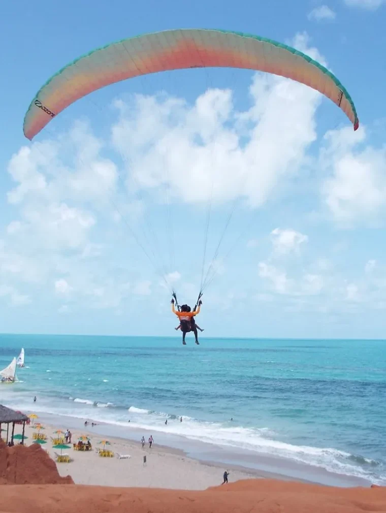 Paraglider flying above the beach of Canoa Quebrada in Ceará